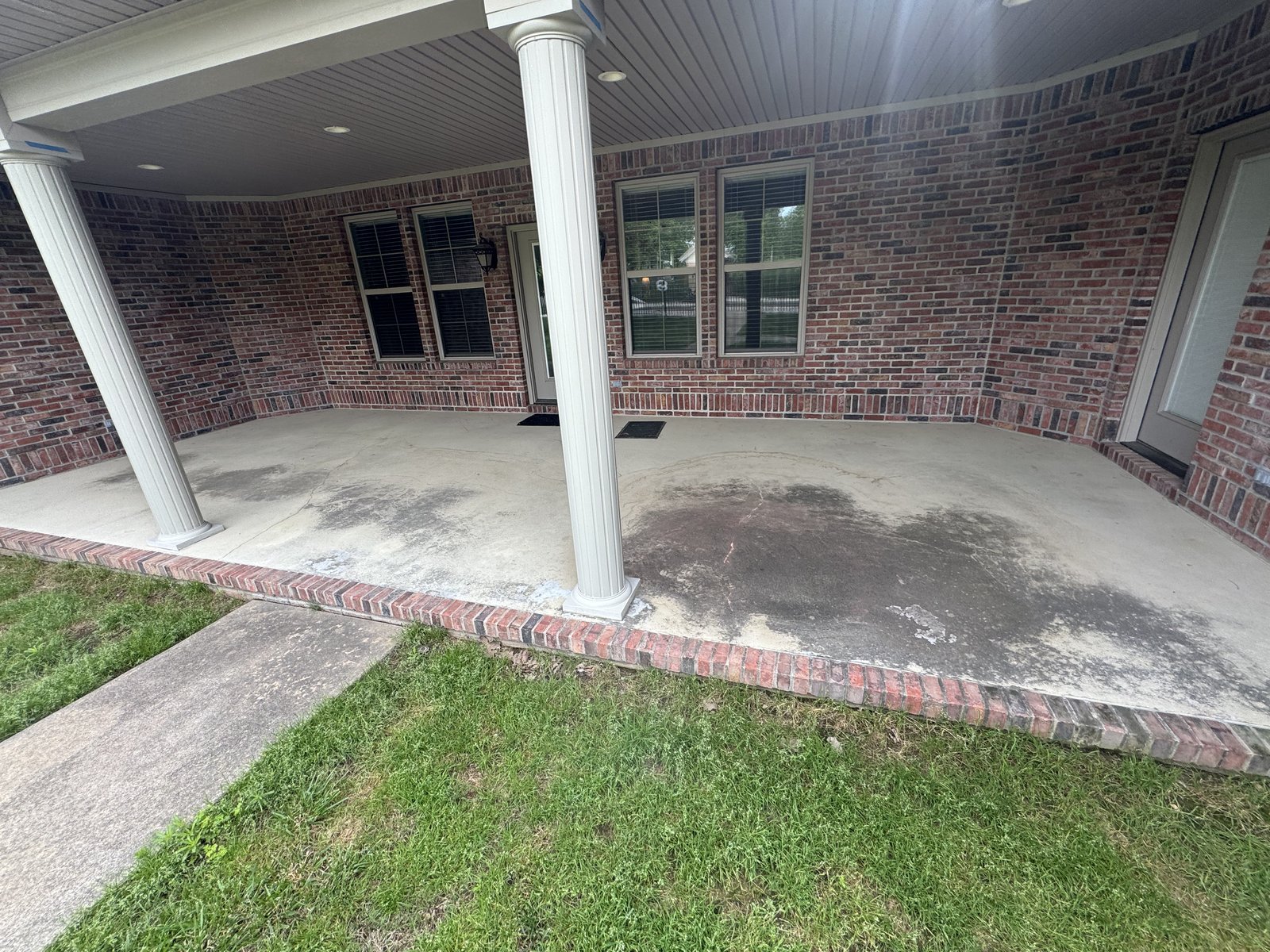 Covered brick porch before pressure washing
